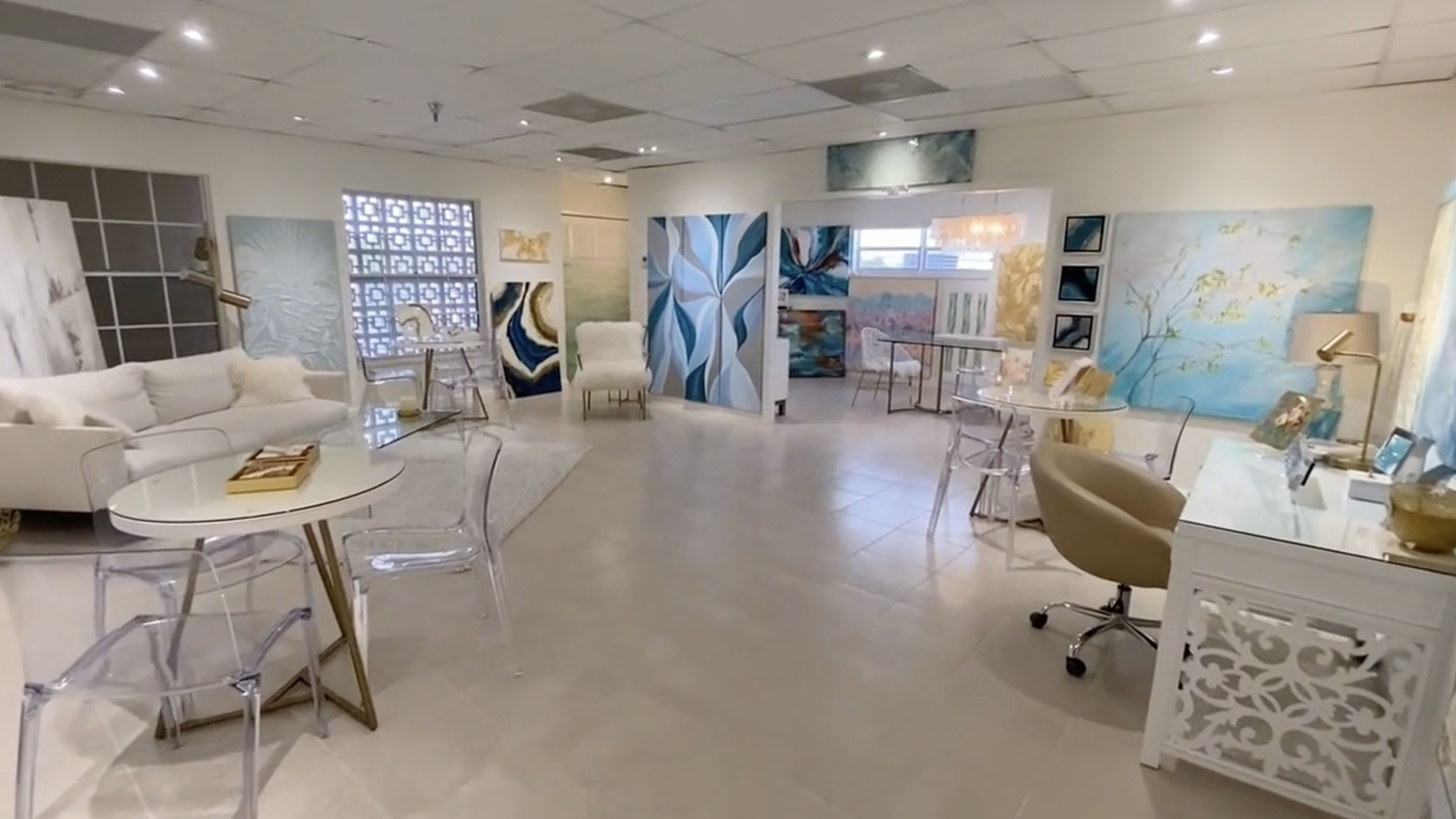 Collette’s Cape Coral studio with original paintings, sculptural art and white seating